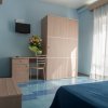 Camera con letto blu, armadio e fiori.