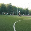 Persone giocano a calcio su un campo verde.